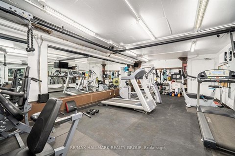 A gym with a variety of equipment including treadmills, weights, and exercise machines.