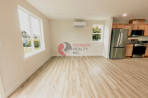 A room with a RODMAN REALTY INC. logo on the wall.