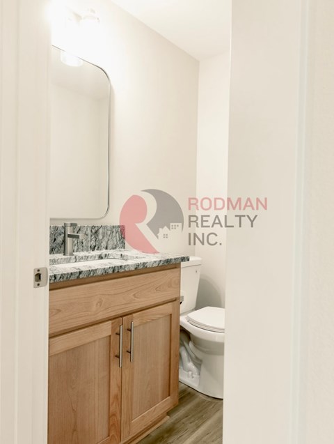A bathroom with Rodman Realty Inc. watermark.