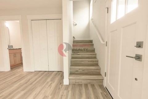 A staircase with a white door on the right side.