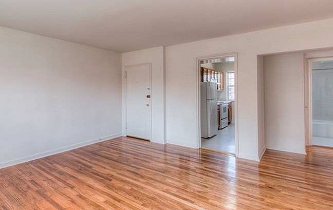 A room with wooden floors and white walls.