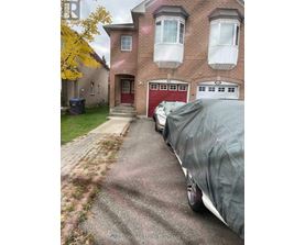 A red garage door is on the brick house.