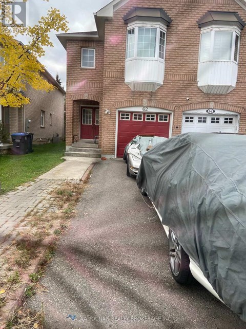 A red garage door is on the brick house.