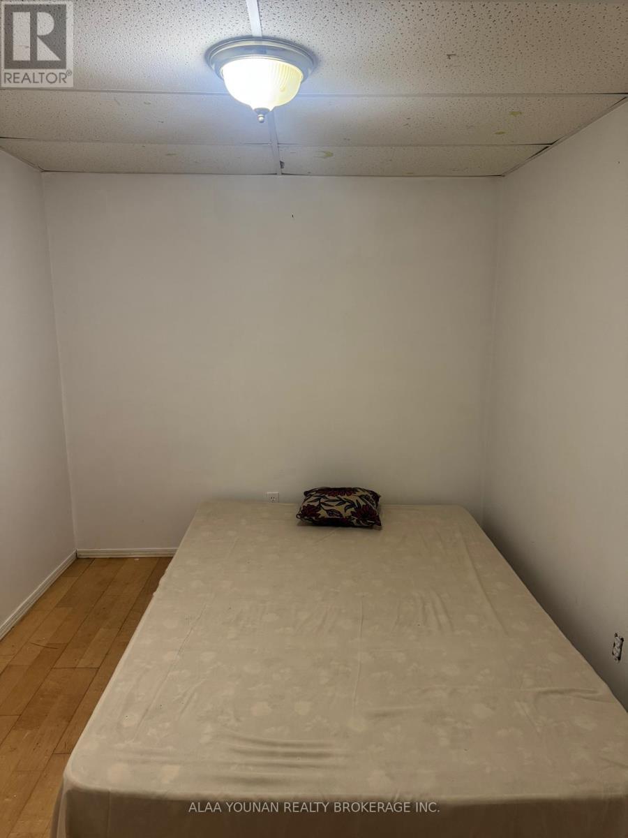 A bedroom with a bed and a pillow.