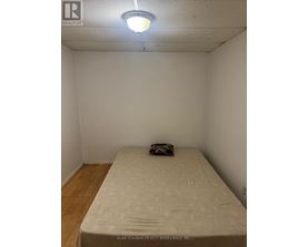 A bedroom with a bed and a pillow.