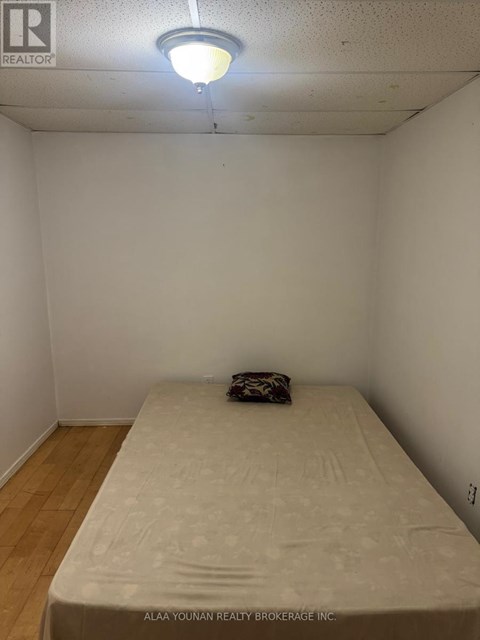 A bedroom with a bed and a pillow.