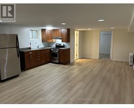 A kitchen with wooden floors and a refrigerator.