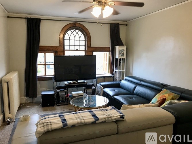 A living room with a television, a couch, and a coffee table.