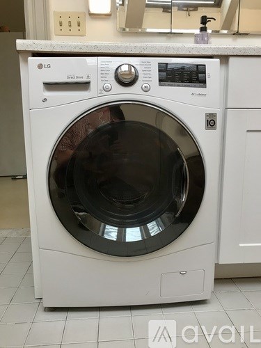 A white LG front loading washing machine in a laundry room.