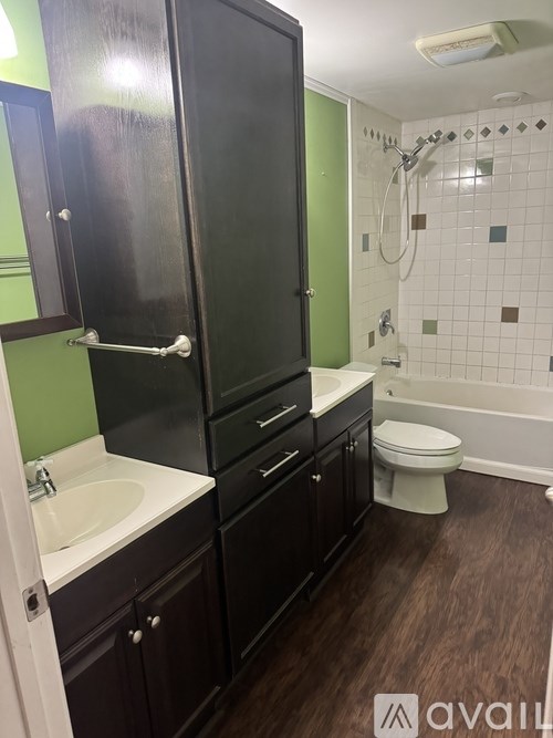 A bathroom with a sink, toilet, and shower.