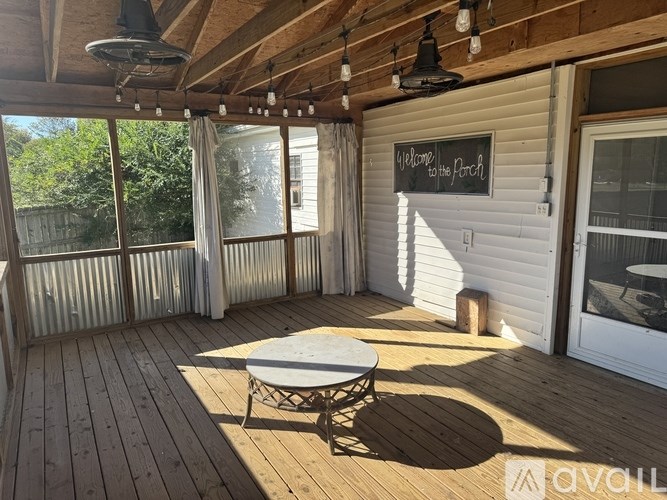 A wooden deck with a table and chairs and a sign that says "Welcome to the Porch".