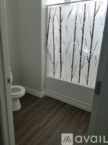 A bathroom with a toilet and a frosted glass door.