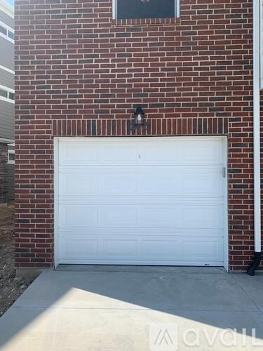 A white garage door is closed and locked.