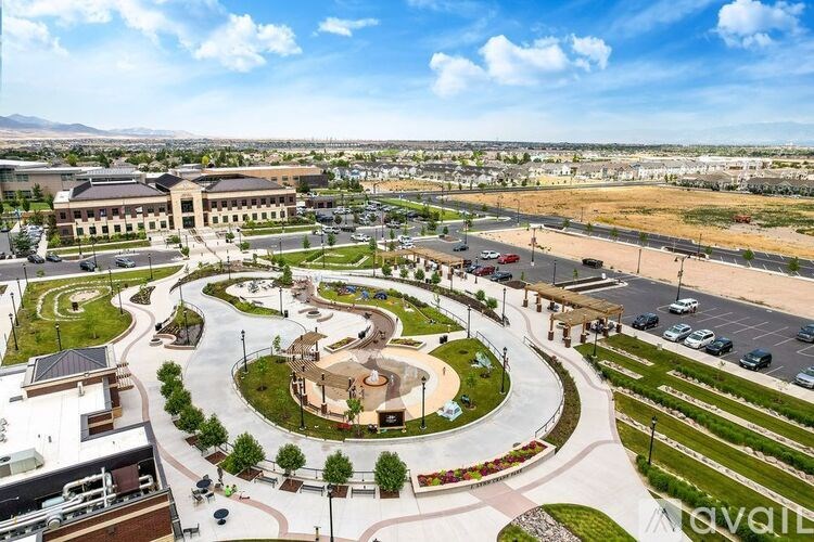 A large open plaza with a circular design in the middle of a parking lot.