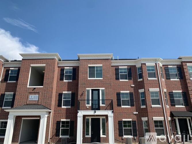 A red brick building with black shutters and white trim.