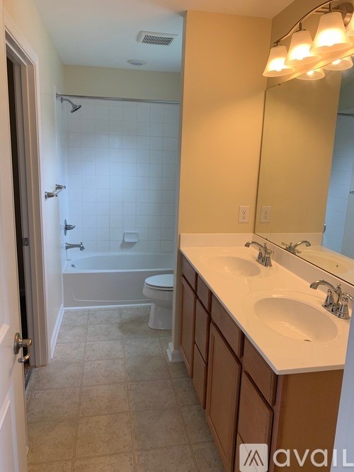 A bathroom with a toilet, sink, and shower.