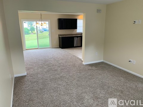 A living room with a television and sliding glass doors.