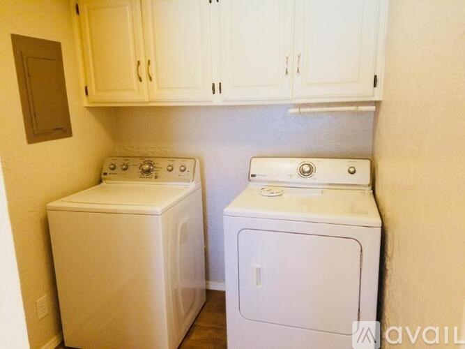 A small laundry room with a washer and dryer.