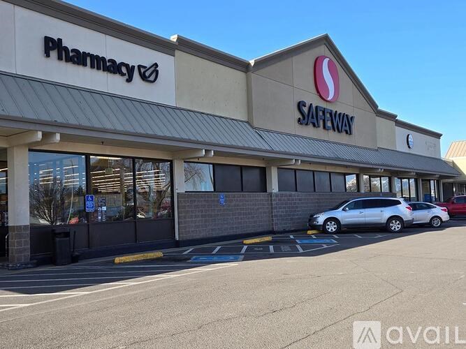 A Safeway pharmacy with a car parked in front.