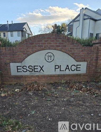 A sign that reads "Essex Place" is mounted on a brick wall.