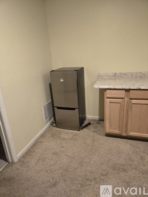 A room with a filing cabinet and a desk.