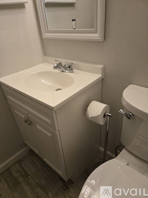 A sign that says "PICTON" is surrounded by flowers.