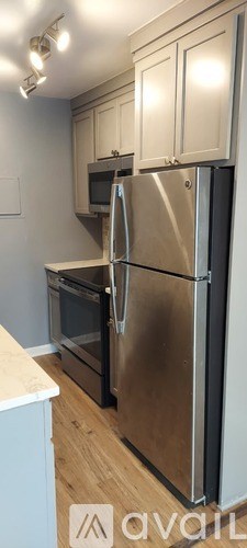 A kitchen with a stainless steel refrigerator and oven.