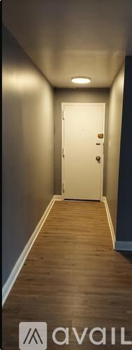 A long hallway with a door at the end.