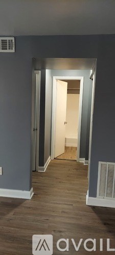 A hallway with a door at the end.
