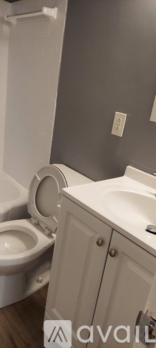 A white toilet is next to a white sink in a bathroom.