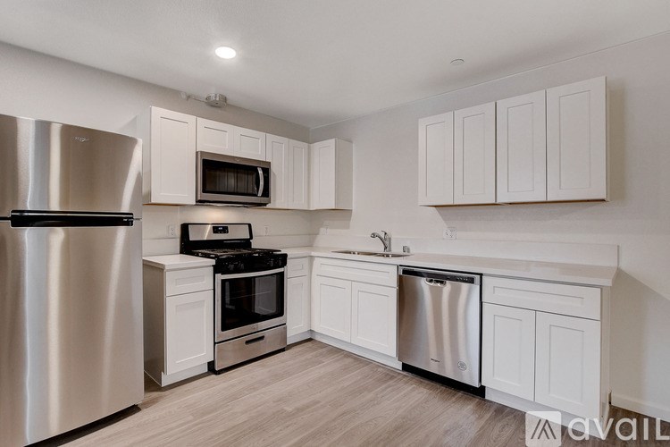 A kitchen with white cabinets and stainless steel appliances.
