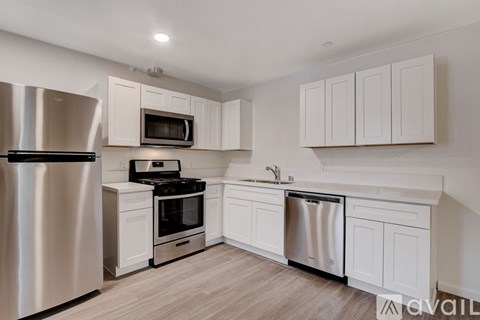 A kitchen with white cabinets and stainless steel appliances.