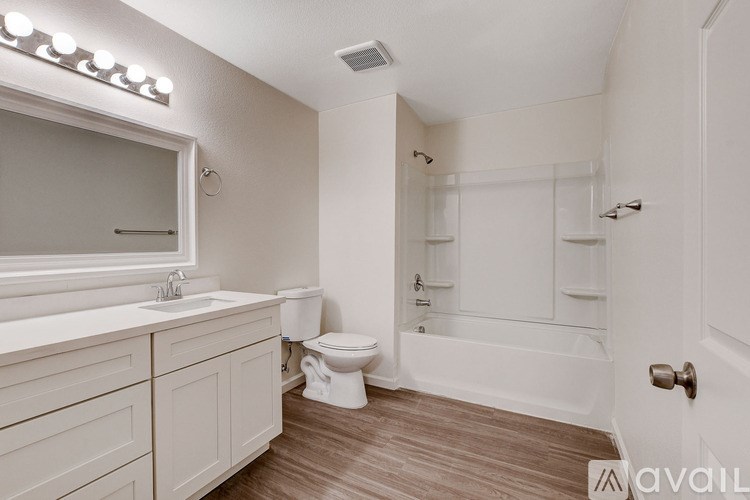 A bathroom with a toilet, sink, and bathtub.