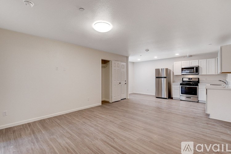 A kitchen with a stainless steel refrigerator, oven, and microwave.
