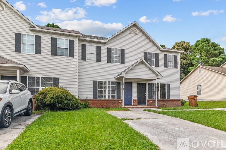 A house with a car parked in front of it.