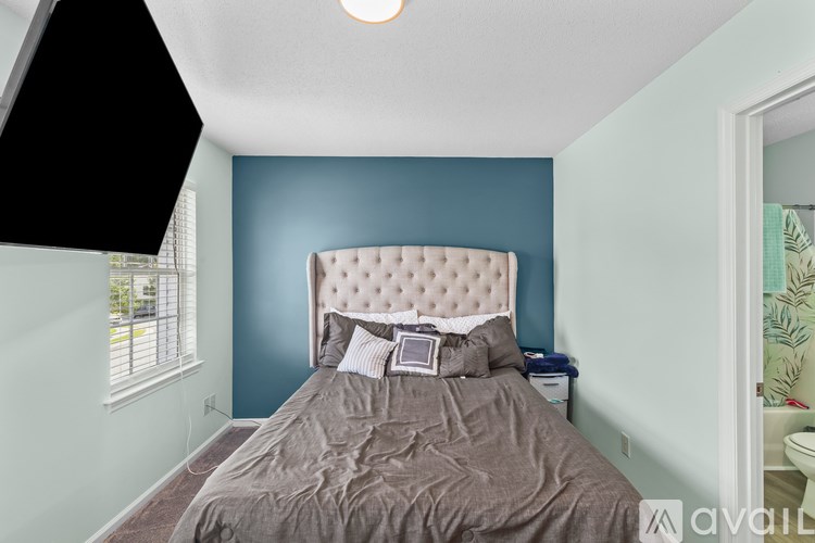 A bedroom with a large bed and a window.