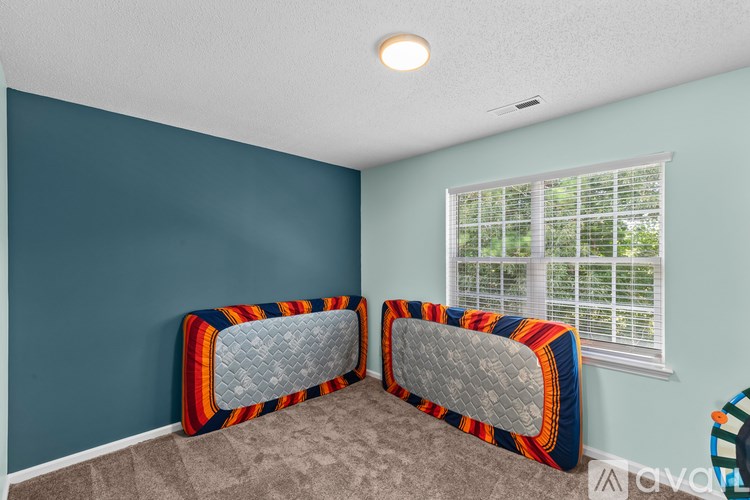 A room with two single beds and a window.