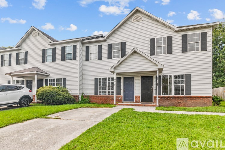 A house with a car parked in front of it.