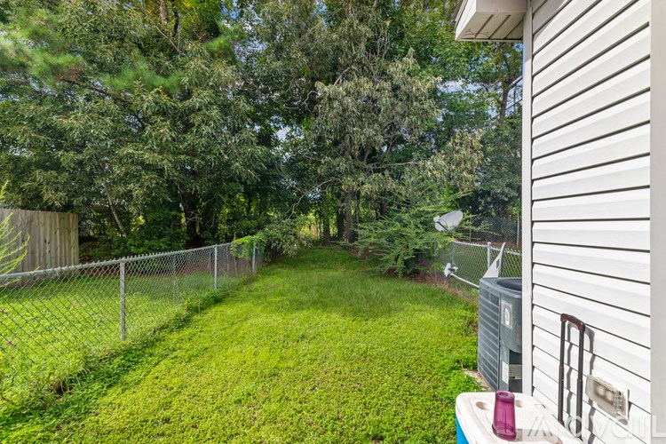 A backyard with a fence and a shed.