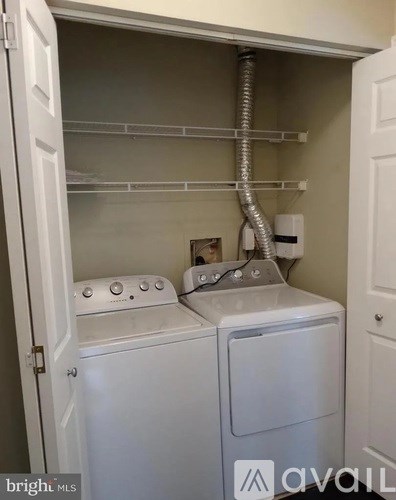 A white washer and dryer in a small laundry room.