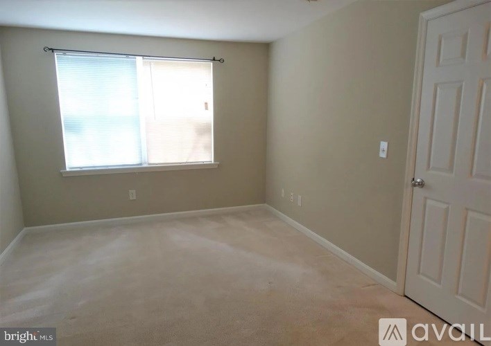 A room with a window and a door is available for rent.