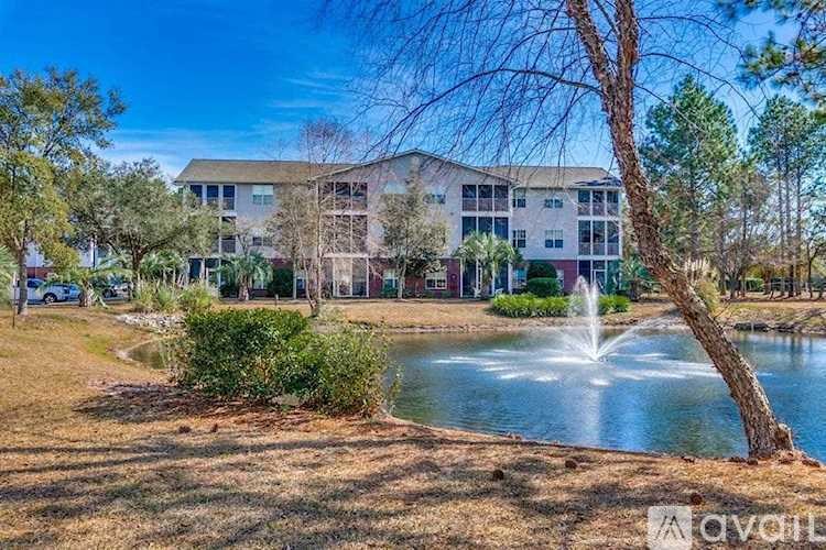 A building with a fountain in front of it.