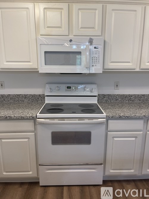 A white oven and microwave in a kitchen.