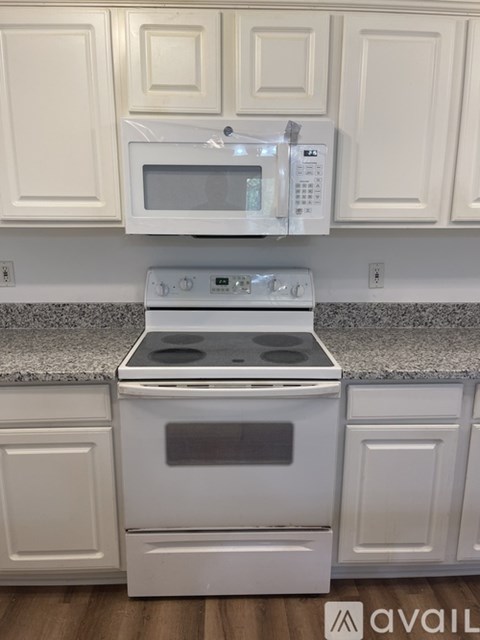 A white oven and microwave in a kitchen.
