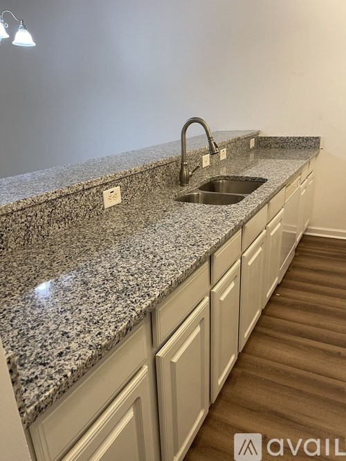 A kitchen with granite countertops and a sink.