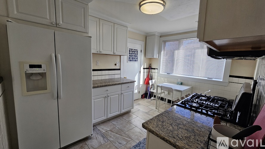 A kitchen with a table and chairs by the window.
