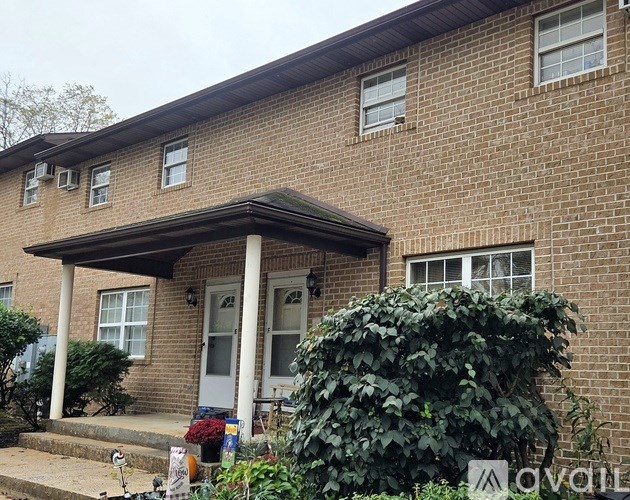A house with a white door and a covered porch.