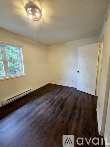 A room with a window and a door.