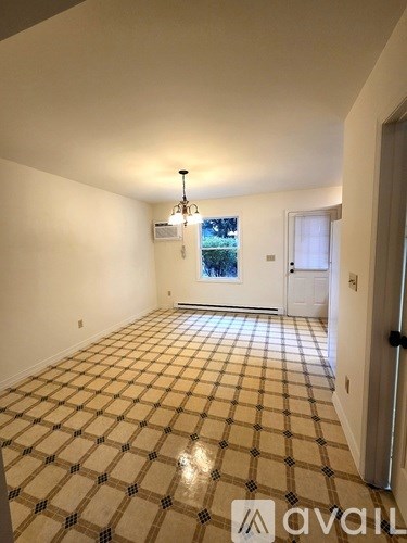 A room with a checkered floor and a chandelier.