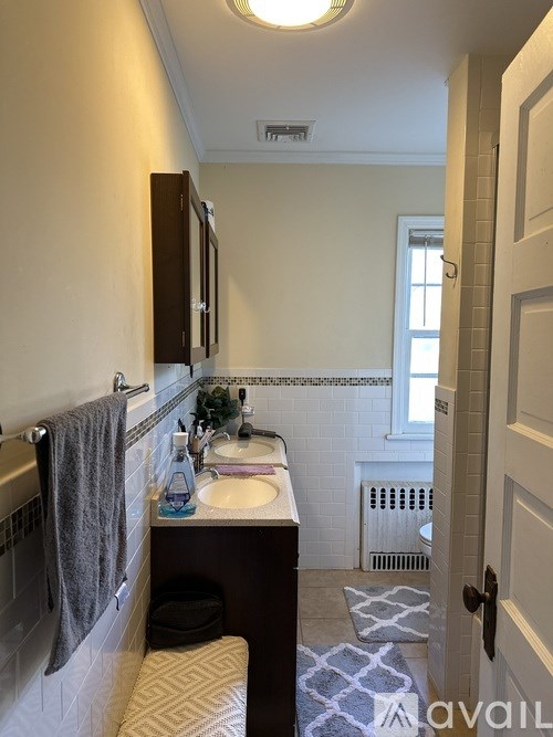 A bathroom with a towel hanging on the rack.